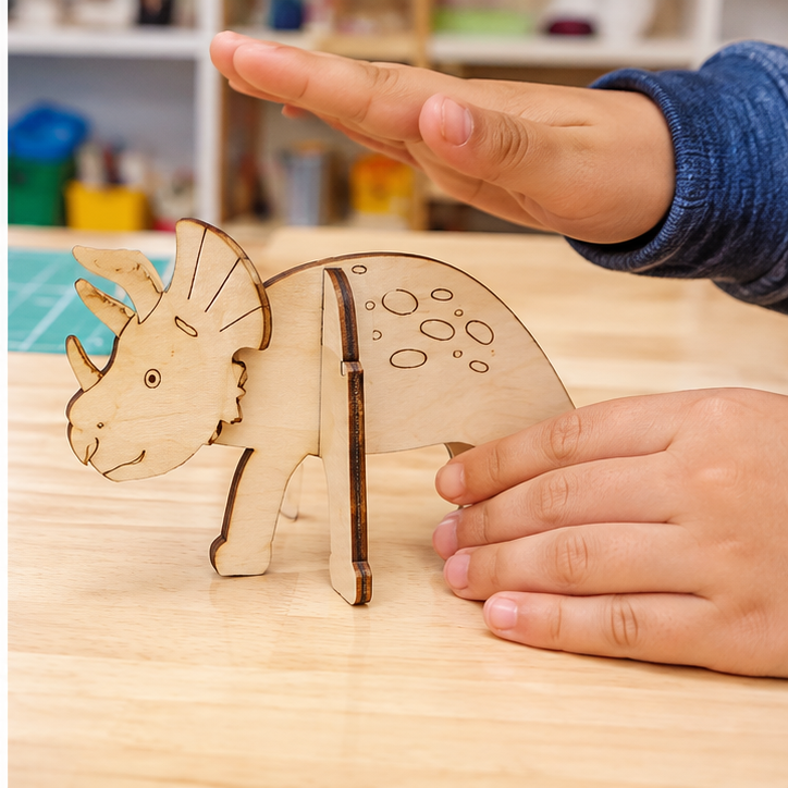 Student hands assembling and gently testing the same standing animal